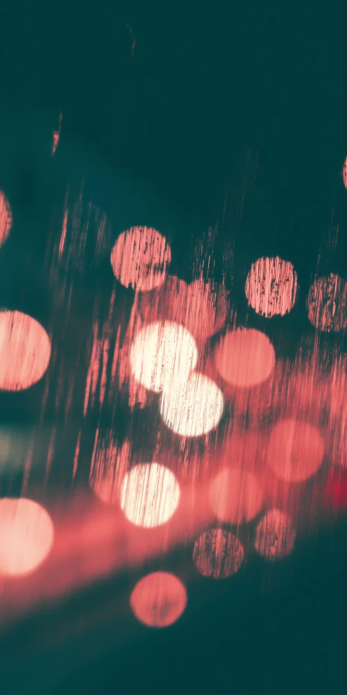 A blur of lights is seen on a wet surface wallpaper