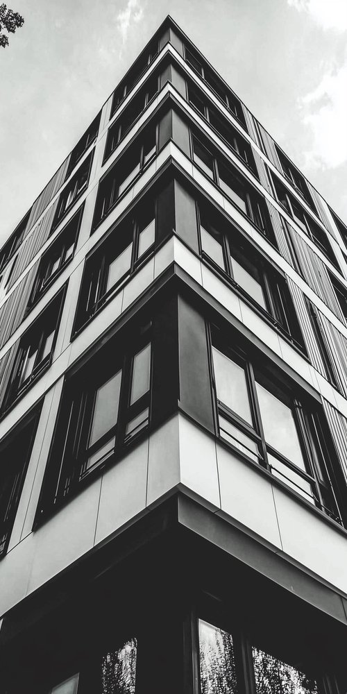 A tall building with many windows and bales wallpaper